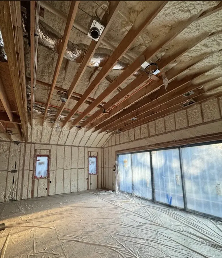 Interior walls and ceiling insulated with spray foam during new construction in Heartland